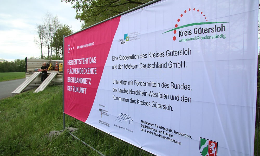 Ein großes Bau-Plakat informiert über den Start des Breitbandausbaus. . - © Kreis Gütersloh